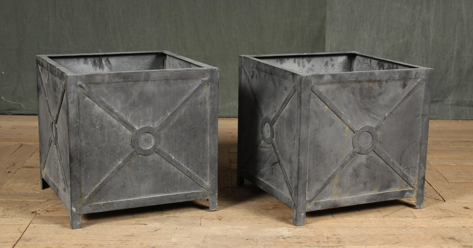 Pair Regency Style Steel Planters: A pair of metal Regency style green planters with x-form sides. Size: 17"H x 17"W x 17"D