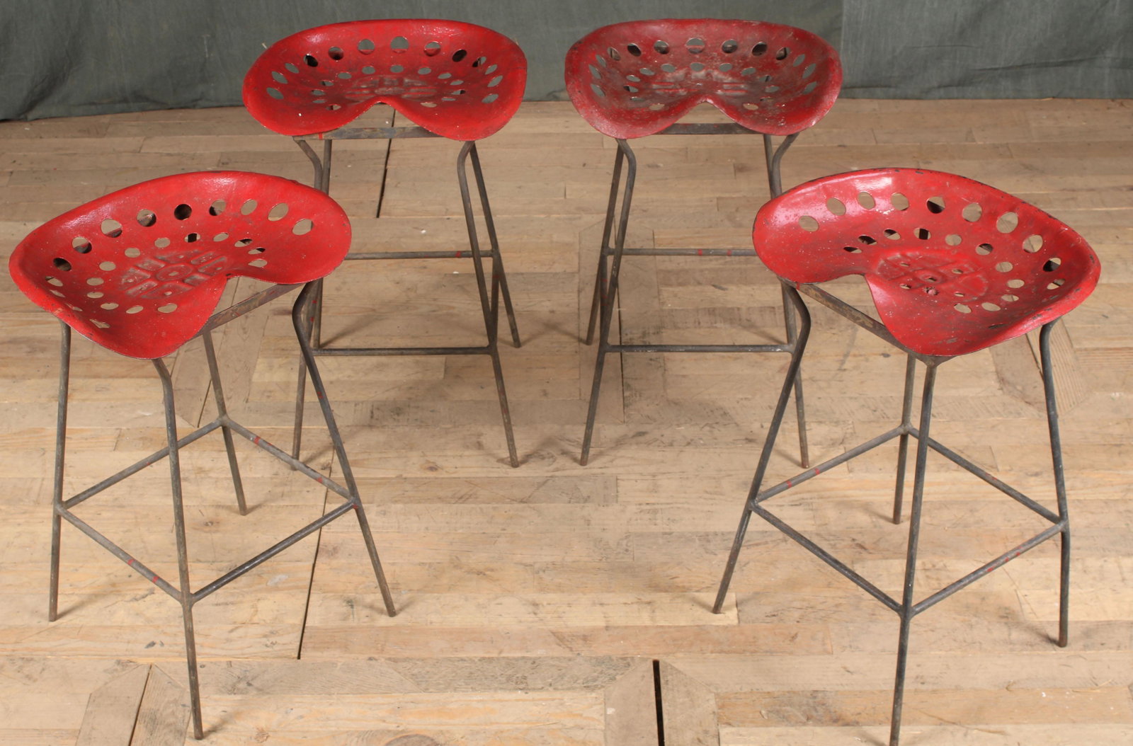 Tractor Seat Barstools: Interesting set of four modernist bar stools having vintage tractor seats supported by wrought iron bases. Size: 26.5"H x 18"W x 13"D