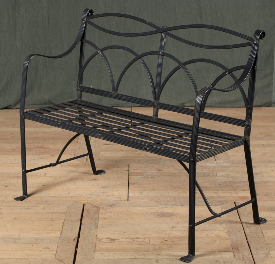 Regency Style Garden Bench IMO Winterthur: A Regency style wrought iron garden bench with reeded down swept arms and paw feet. Size; 37"H x 44.5"W x 24"D