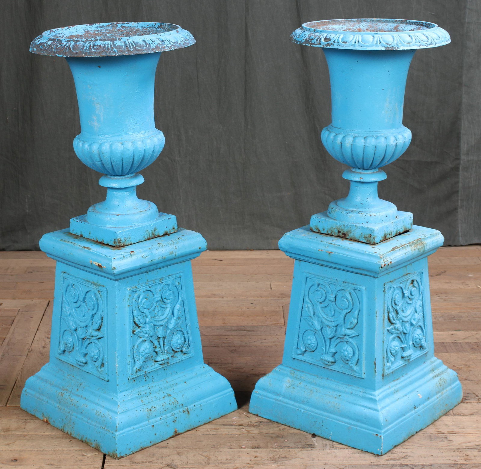 Fun Pair Cast Iron Garden Urns on Bases: A pair of cast iron campana form garden urns raised on tapered base. Size: 35"H x 14" Dia.