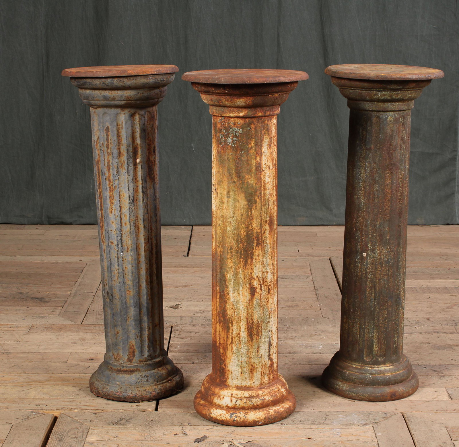 3 Cast Iron Column Pedestals: A lot of three cast iron fluted column form pedestals. Size: Tallest 30"H