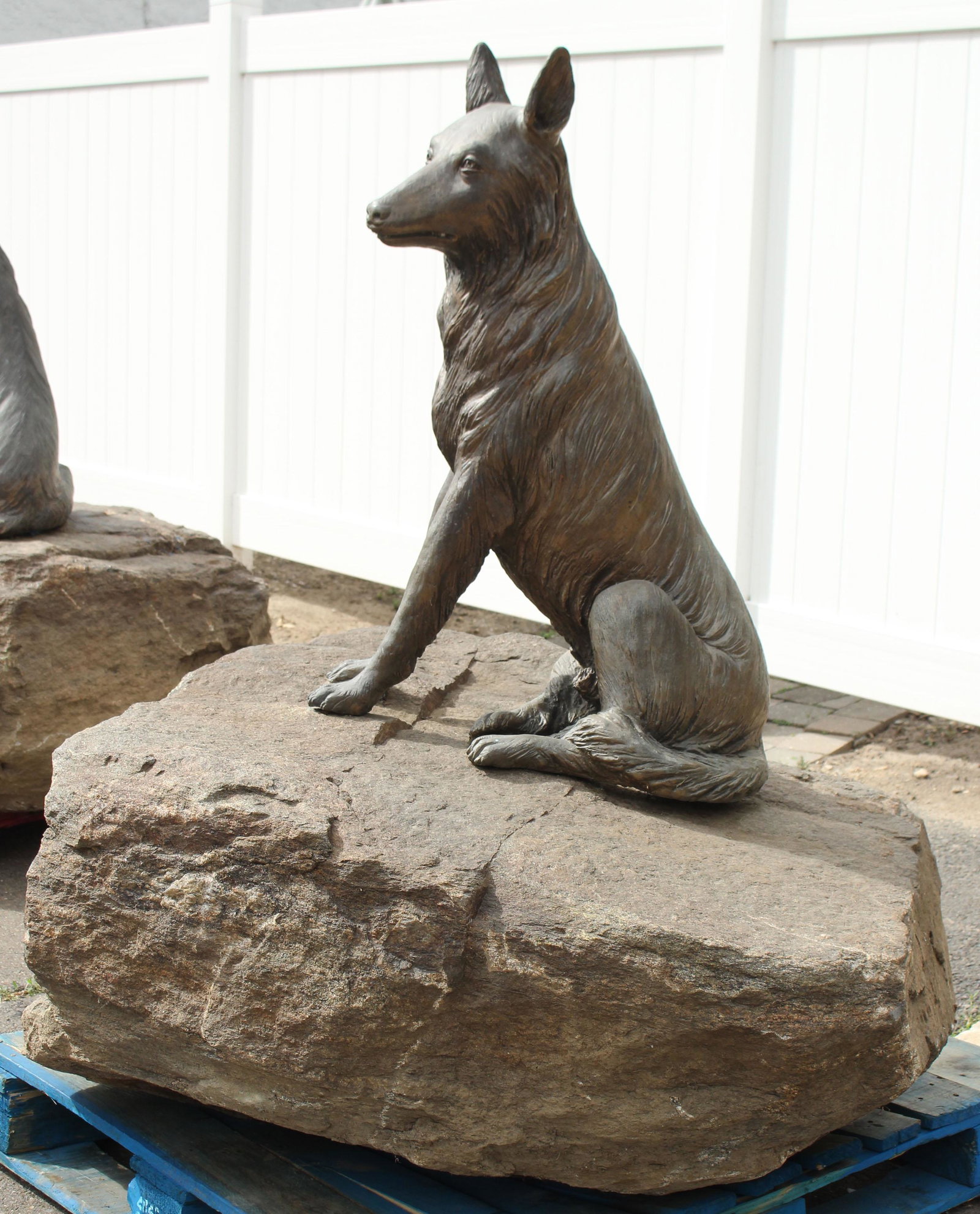 Figural Bronze Shepherd Atop a Boulder: Figural Bronze Shepherd Atop a Boulder. Size: 58" overall height. Dog 35" x 24" x 16" rock irregularly shaped at 22" H x 43" W x 43" D