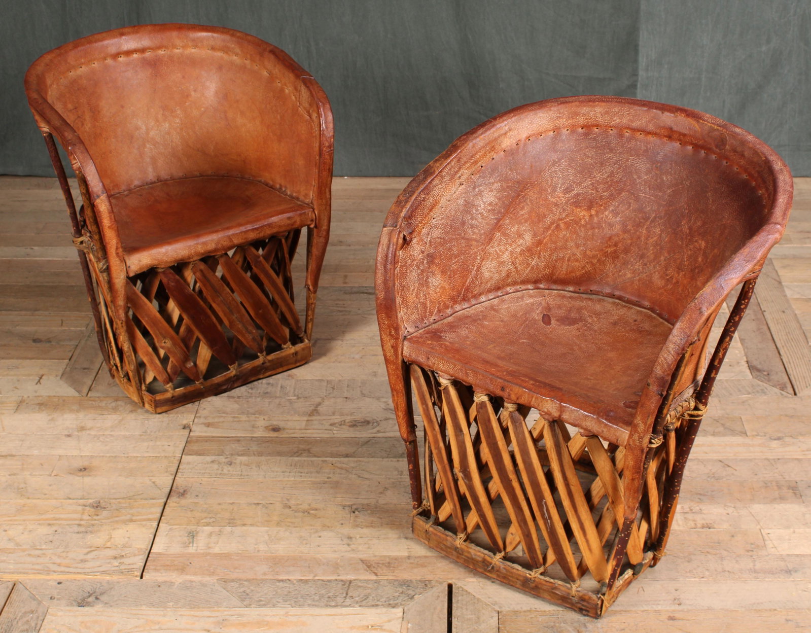 Pair Vintage Equipale Chairs: Pair Equipale Chairs. A few small holes in the leather of one chair, pictured. Size:27.5"T x 22"L x 16"W