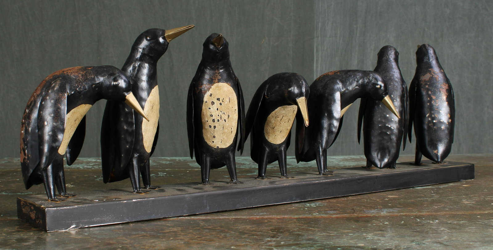 Decorative Painted Metal Penguins in a Row: Decorative Painted Metal Penguins in a Row. Dimensions: 31.5"L x 9.75"T x 4"D