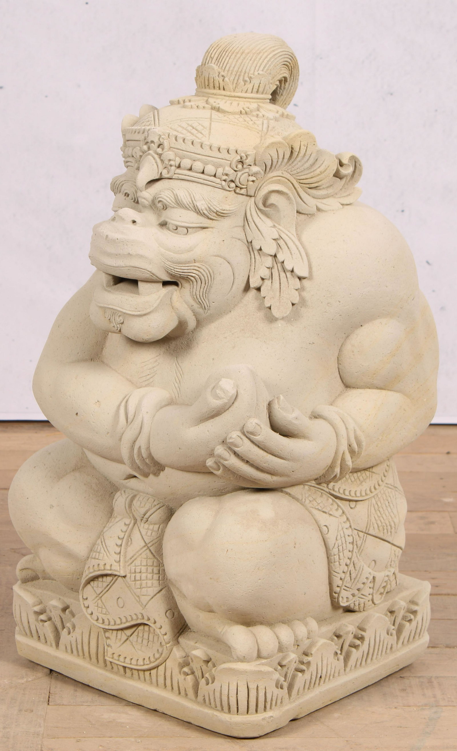 Carved Tuff Stone, Simian Deity: A craved stone garuda with crown and crossed legs. Size: 25"H x 11"W x 11"D