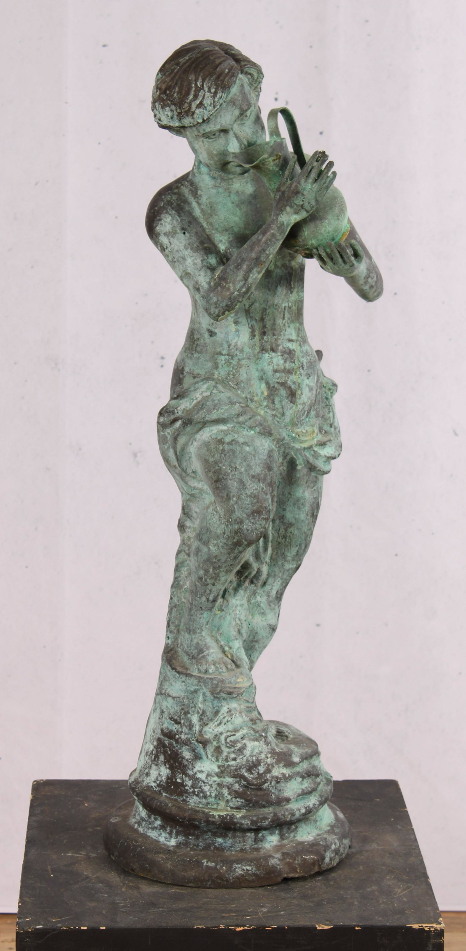 Verdigris Hollow Cast Fountain: Interesting repousse copper or light bronze figural fountain having Neoclassical figure holding an ewer and standing on a naturalistic base. Size: 32"H x 12"W x 10"D