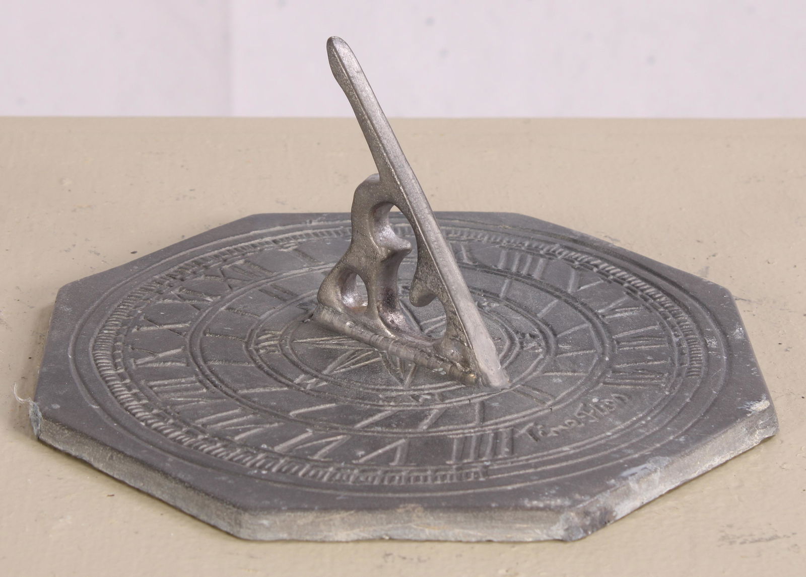 Octagonal Lead Sundial: An English cast lead octagonal sundial inscribed "Time Flies". Measured: H 4" x Dia. 8"
