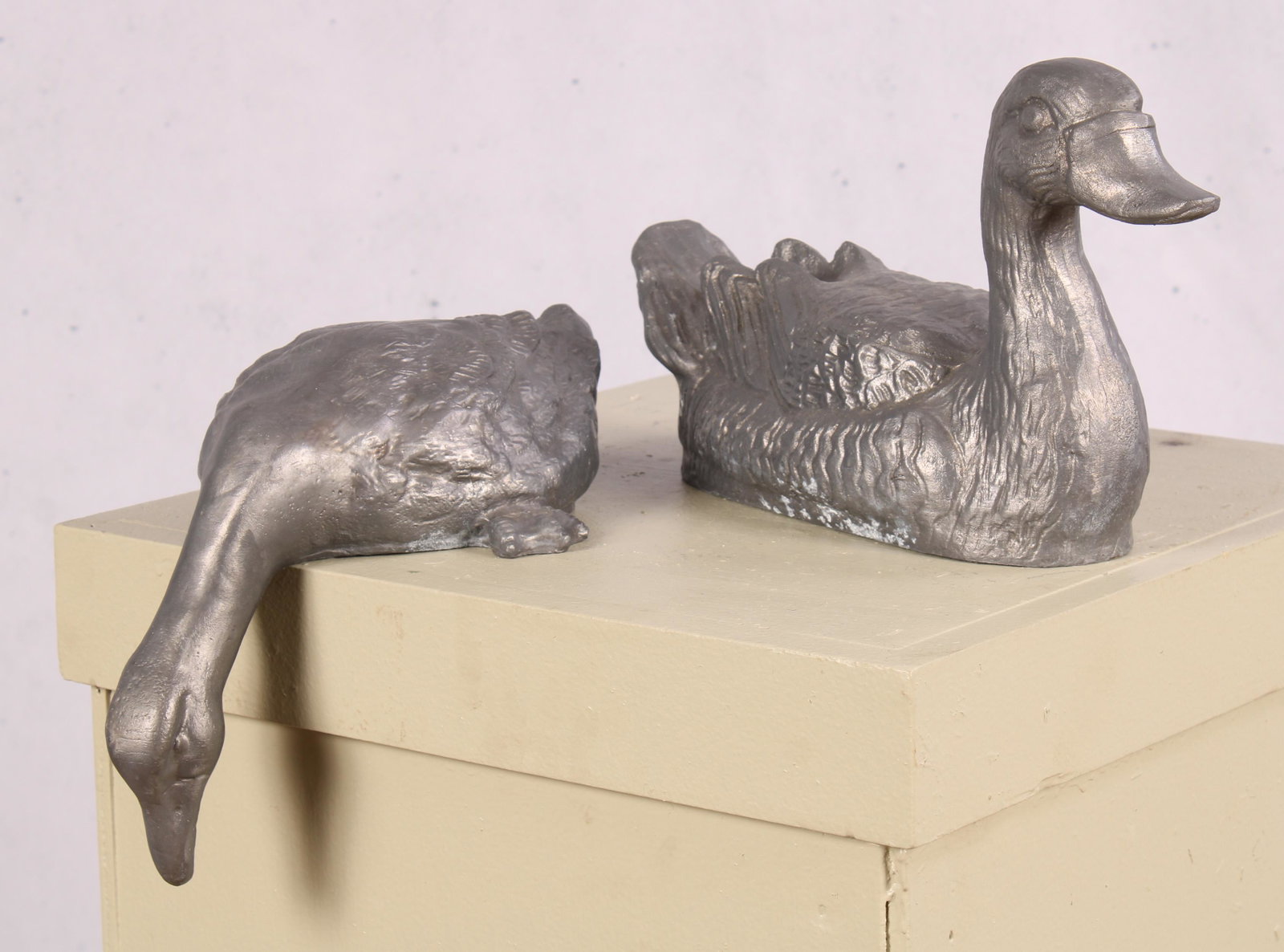 Group of Figural Lead Duck, Garden Decor: An associated pair of cast lead ducks one swimming the other reaching down for a fish. Size: 8"H x 5"W x 14.5"D