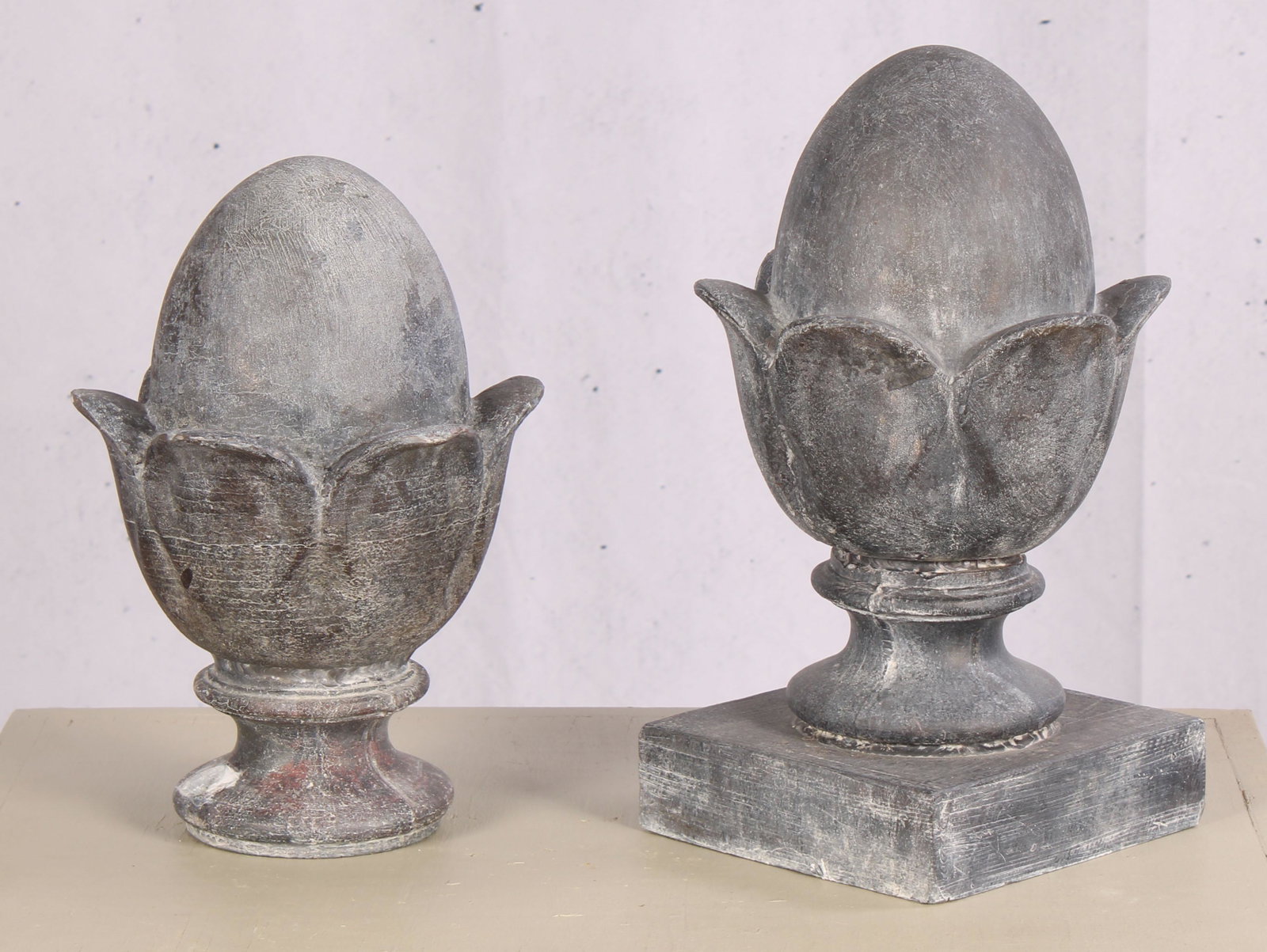 Lot of 2 Cast Lead Acorn Finials: A similar pair of cast acorn finials one with additional plinth base. Largest 14.5"H x 7"W x 7"D