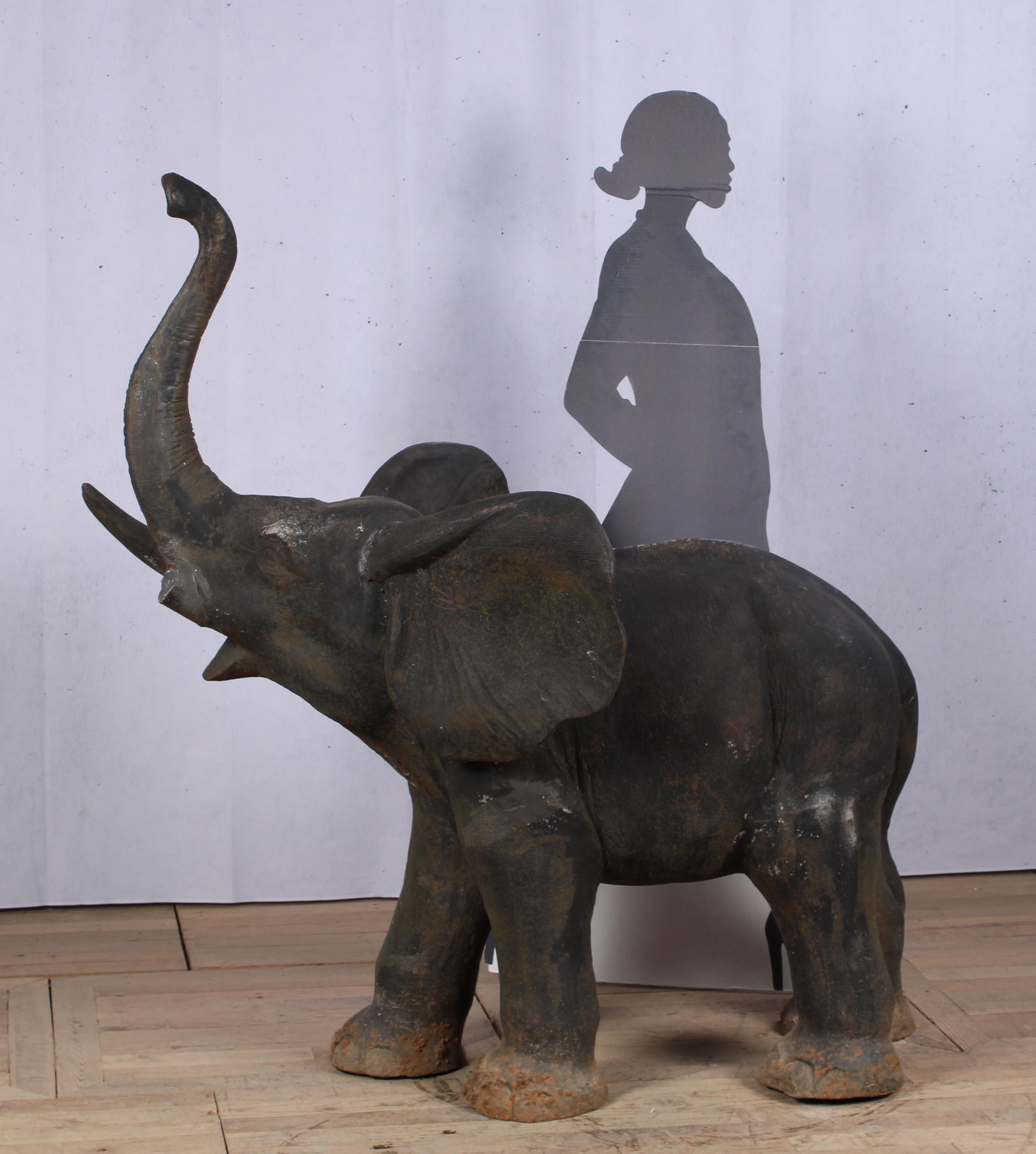 Garden Statue, Cast Iron Elephant: A good cast iron elephant with upraised trunk. Great scale for the garden. Missing tusk. Size: 58.5"H x 56"W x 31"D