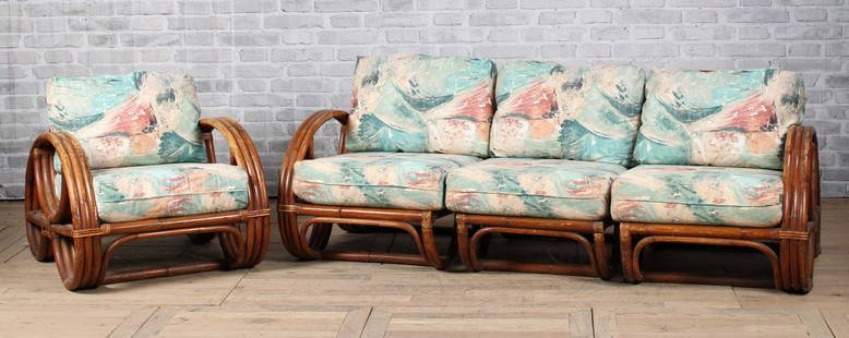 Far East Rattan Co. Seating Group: A vintage Paul Frankl style rattan set including a three piece sofa and matching arm chair all with pretzel form arms. Couch: L 28.5" x W 77" x D 35" & Chair: L 28" x W 29.5" x D 36"