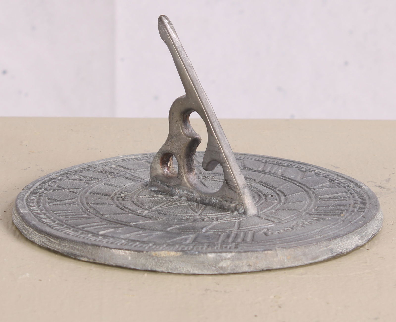 English Lead Sundial: An English cast lead sundial inscribed "Time Flies" Measured: H 4.5" x W 7.5"