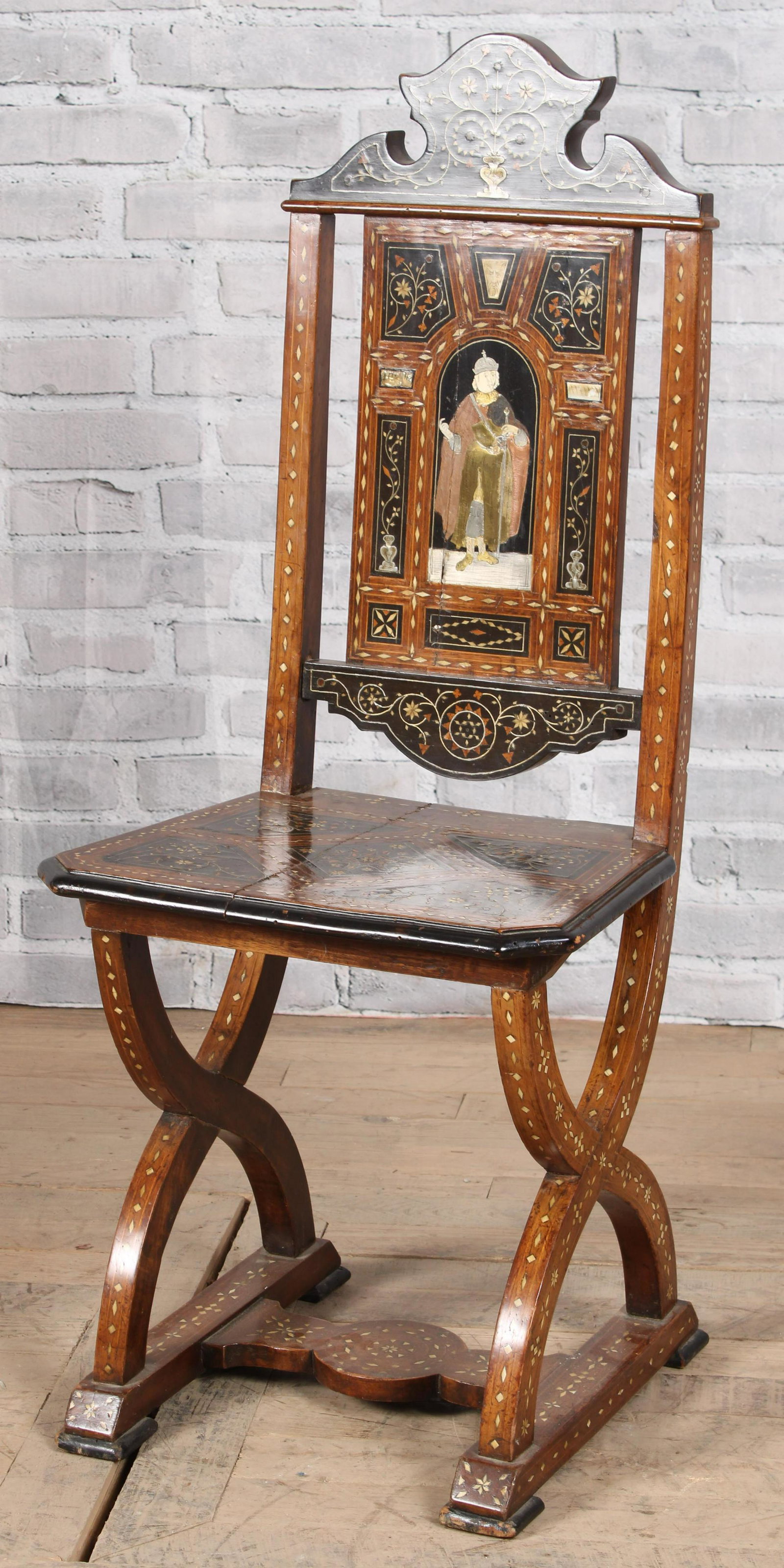 Italian Inlaid Court Chair: A good Italian 19th century inlaid court chair having bone, pewter and brass marquetry inlaid designs framing a central figure. Measured: H 41.5" x W 17" x D 15.5"