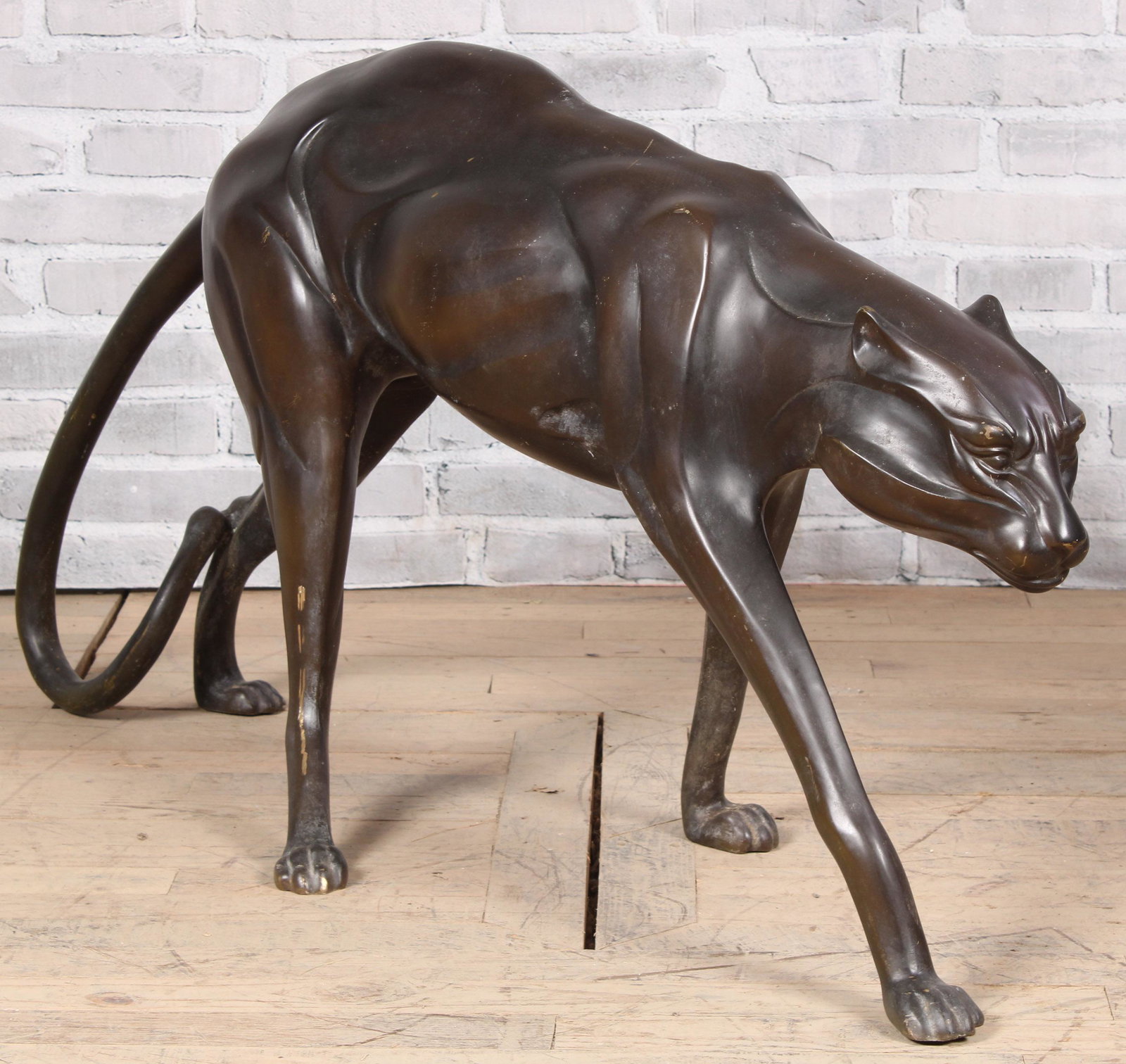 Bronze Cheetah: An Art Deco style bronze Cheetah of a stylized form and grace. Measured: H 27.5" x W 52" x D 16"