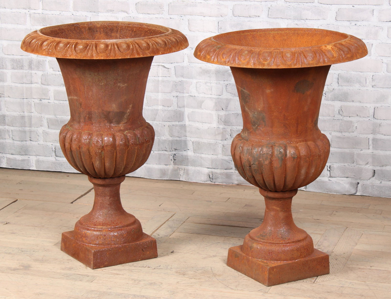 Pair Tall Cast Iron Campana Garden Urns: A pair of campana form cast iron garden urns with egg and dart rims over melon form bowls. Measured: H 36" x W 26" x D 26"