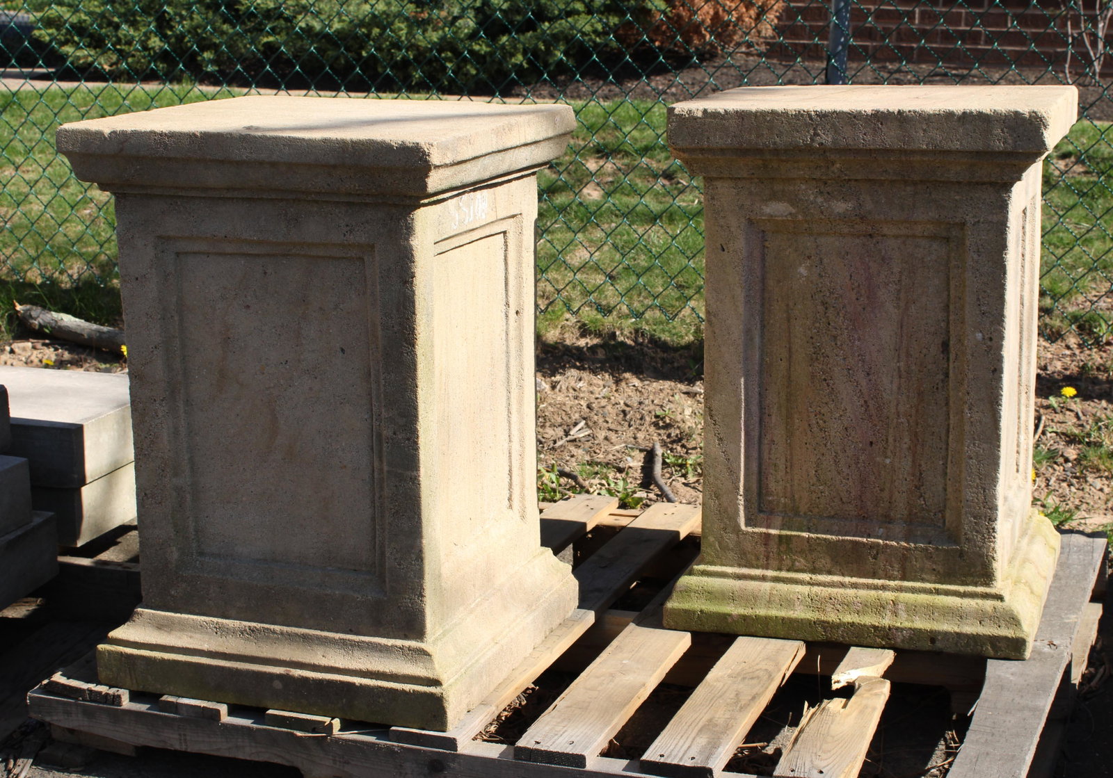 Pair Carved Sandstone Pedestals: Pair of carved sandstone pedestals with classical paneled sides. Measured: 27"T x 18.5"W x 18.5"D