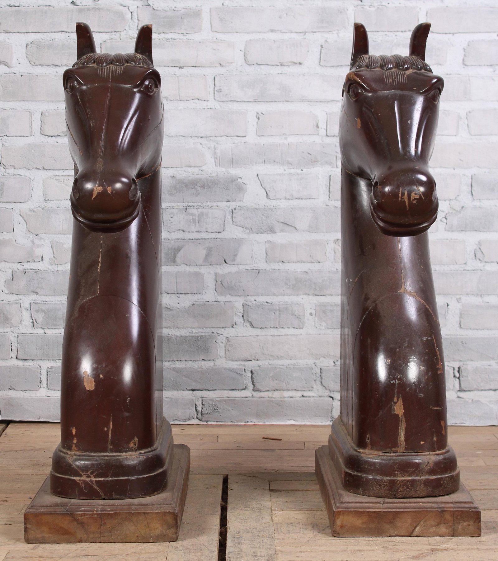 Pair of Carved Wood Horse Heads: An interesting pair of stylized carved wood horse heads, possibly carnival or carousel, each of an elegant form now mounted on later base. Size: 33.5"T x 9.5"W x 19"D