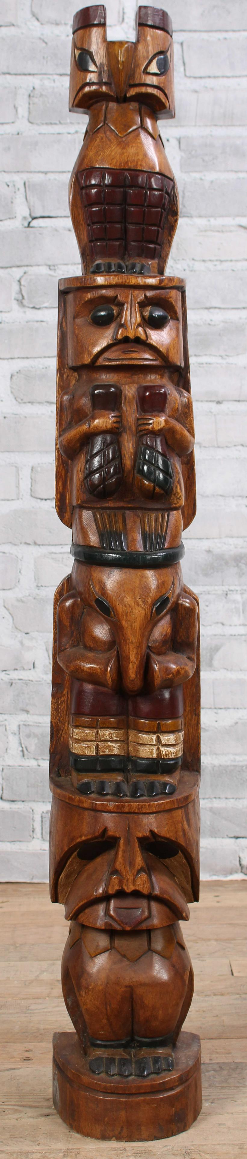 Totem: A Northwest Coast style carved Totem. Size: 50.5"H x 7.5"W x 6.5"D