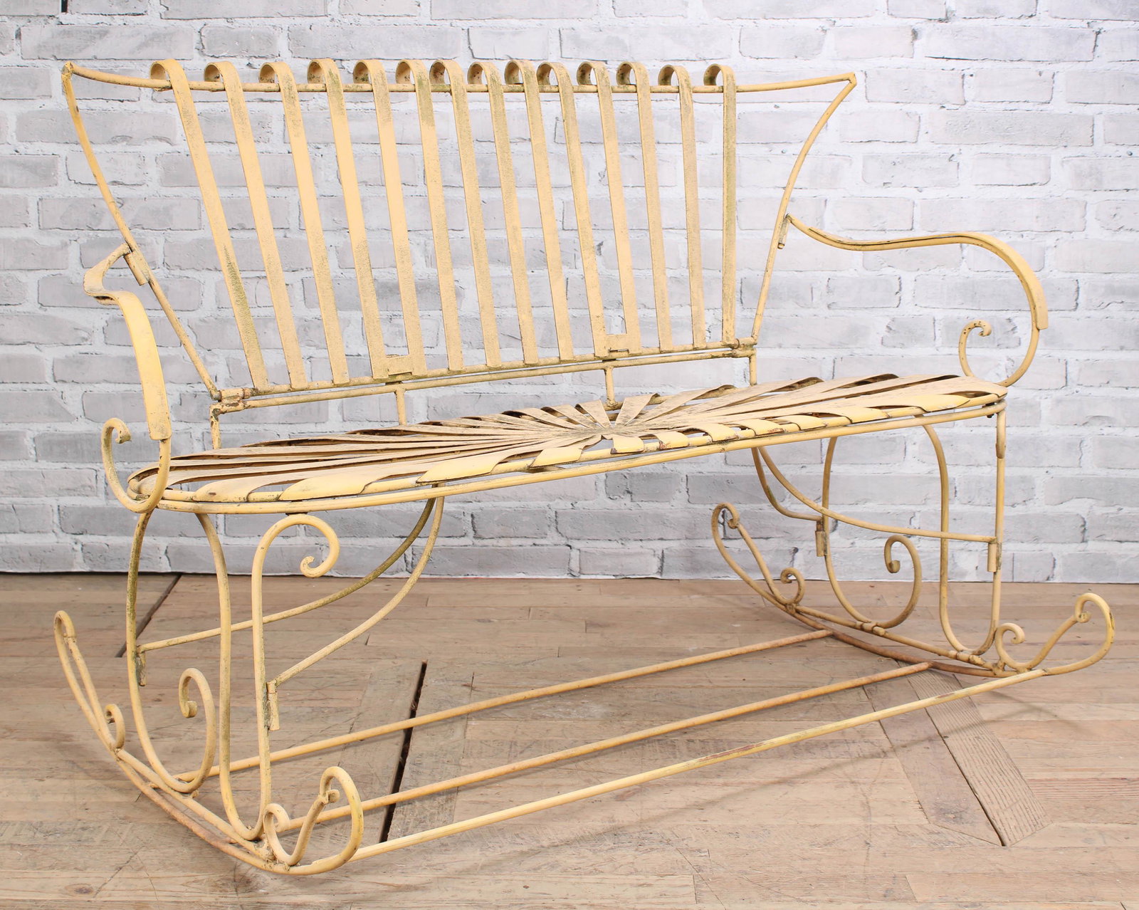 Francois Carre Style W.I. Garden Bench: A Francois Carre style wrought iron garden bench with spring seat, scrolling arms and rocker bases. Size: 37.5"T x 56'W x 36"D