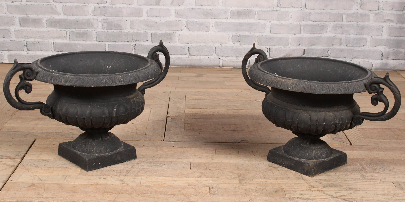 Pair of Black Handled Garden Urns: Pair of cast iron garden urns in black with ornate handles. Size: 17"T x 19" diameter