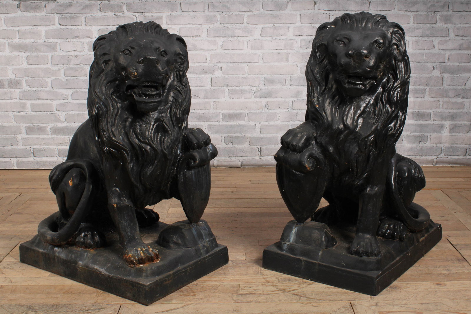 Pair of Cast Iron Entry Lions With Shields: Nice size cast metal lions painted black with one paw on a shield. Size: 36"T x 28"L x 19"D
