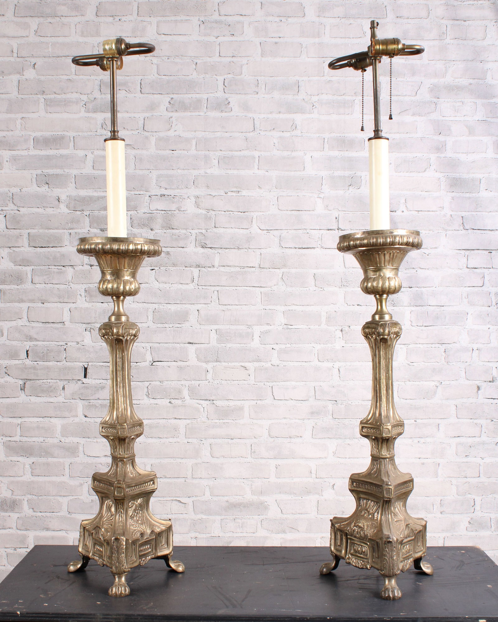 Neoclassical Altar Candle Sticks to Lamps: Ecclesiastical candle sticks turned into a lamp pair. Images of a lamb, wheat sheaf, and holy trinity along with classical paw feet. One missing finial. Untested, rewiring suggested. Size: 44"T x 9"W 