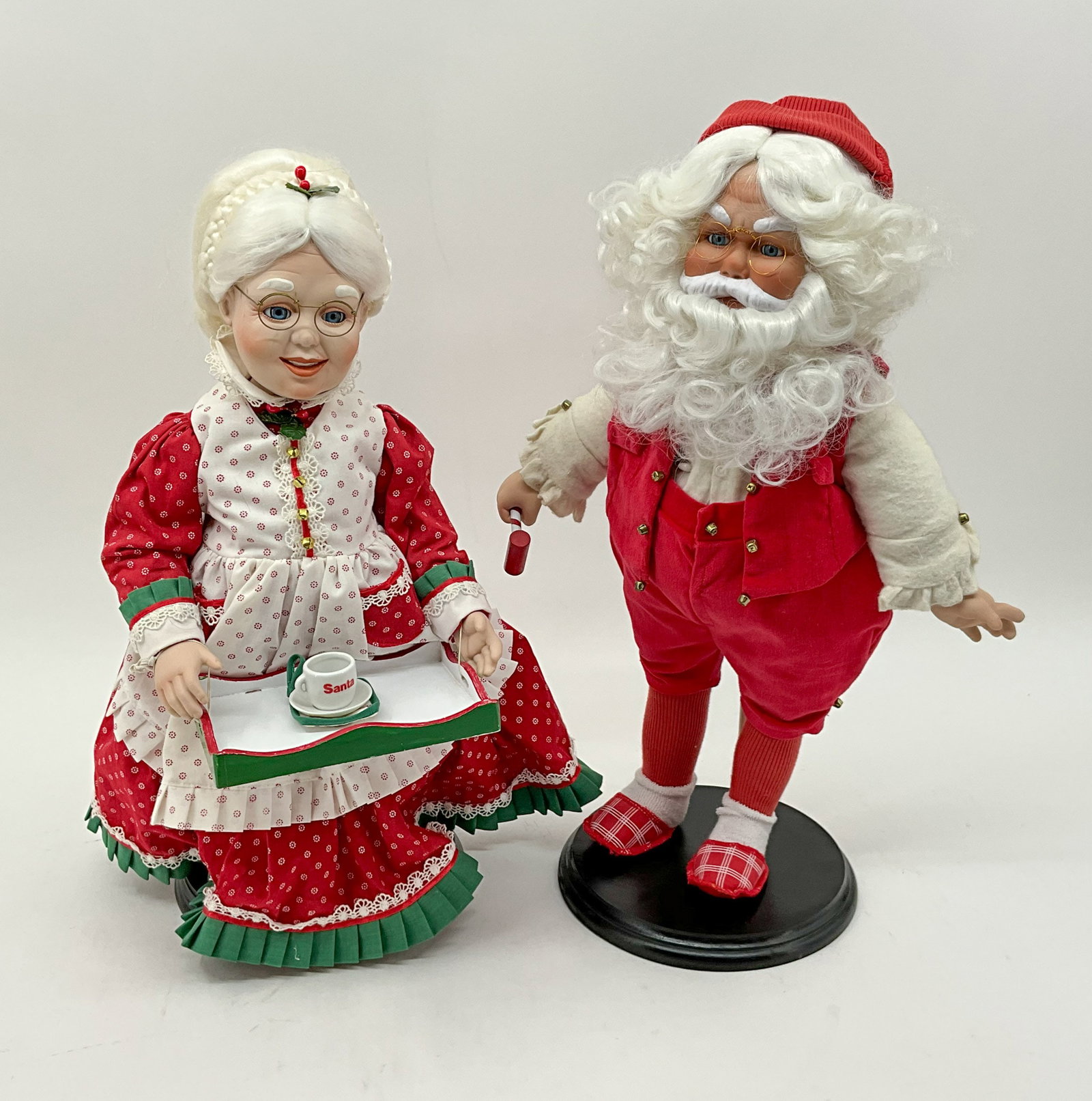Mr & Mrs Claus Figures on Stands: Mr. and Mrs Claus look ready to host a delightful family dinner. Fabric, wood, resin. From a single owner collection, PA estate, stored in a glass cabinet. Size: H 20" x W 13" x D 8" Shipping Note: Fo