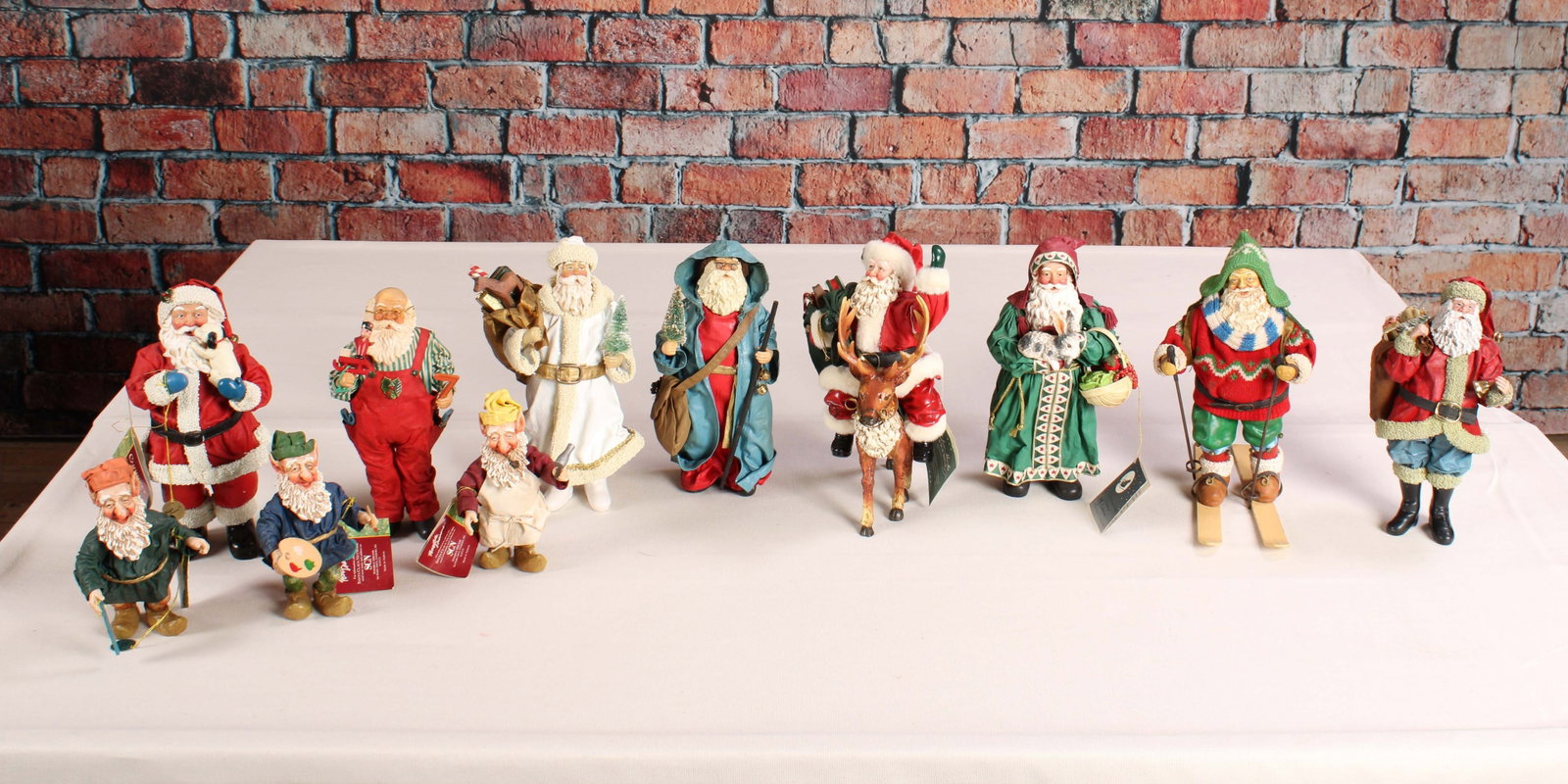Assorted Santas, Fabric and Resin: An assortment of Santa figures, fabric mache and composite resin, Some dated early 1990's. From a single owner collection, PA estate, stored in a glass cabinet. Size: largest 11"T x 6"W x 8"D Shipping