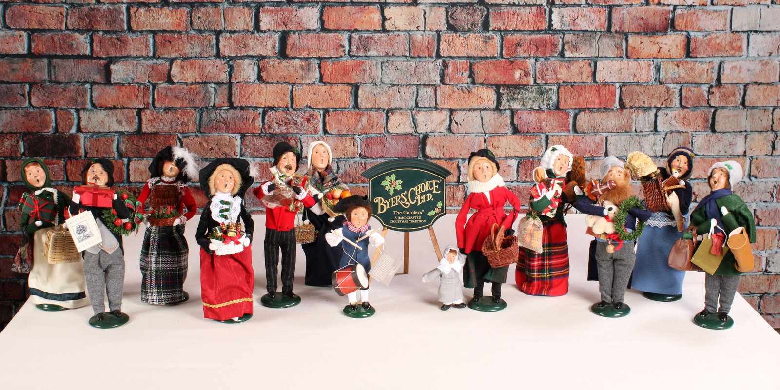 Byer's Choice X Crabtree & Evelyn Carolers: 12 Byer's Choice Carolers including 5 from the Crabtree and Evelyn Collaboration. Some signed and numbered. From a single owner collection, PA estate, box stored. Size: approximately 14"T x 5"W x 5"D 