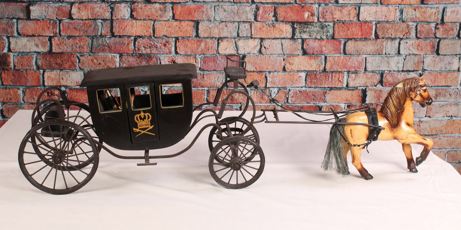 Large Metal Carriage with Horse: Festival metal carriage model with composite, resin horse. Basket of goodies inside carriage. Some chips and losses on the horse. From a single owner collection, PA estate. Size: 15"T x 44"L x 10"W Sh