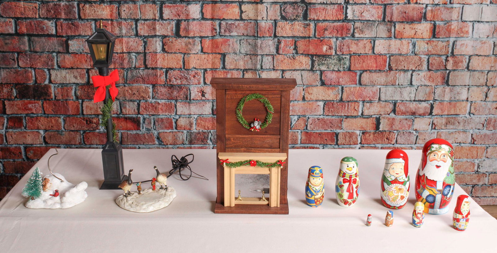 Holiday Lighted Mantles and More: Lighted mantle, untested, street light, untested. Village scenery, and Santa nesting dolls. From a single owner collection, PA estate, box stored. Mantle: H 16.25" x W 8.75" x D 3.75" Shipping Note: F