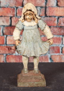 Girl Holding Dress Doorstop, Bradley & Hubbard: Girl holding dress, design # 7789, by Bradley & Hubbard, 2 piece construction with screws to hold base to girl, original paint. Original rubber stoppers still in place. Provenance: Single owner collec