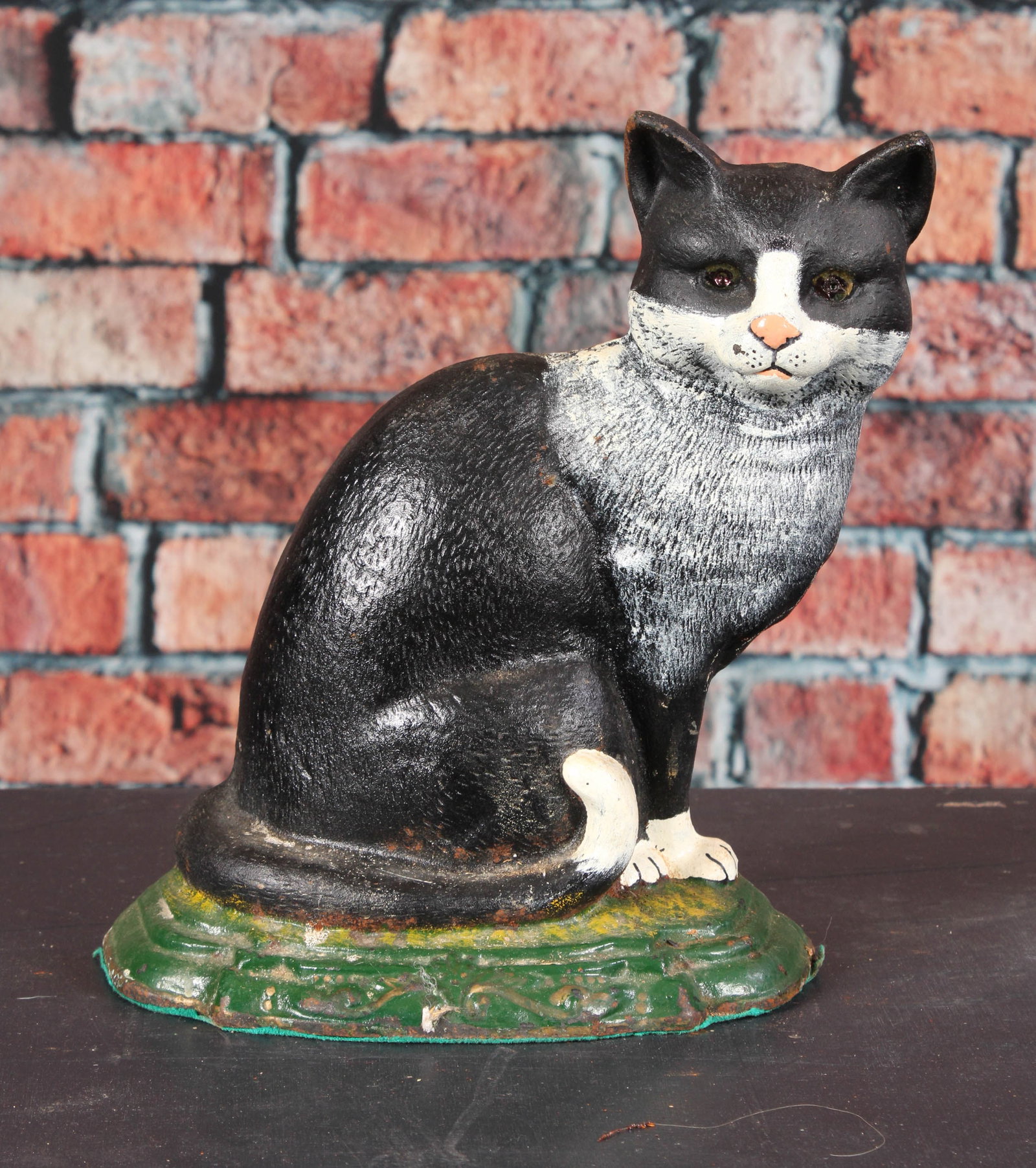 B&W Cat Doorstop Cast Iron: Reproduction tuxedo cat cast iron door stop. Provenance: Single owner collection, suburban Philadelphia estate. Size: 11.5" Shipping Note: For your convenience, we have arranged with Craig Vogin at Th