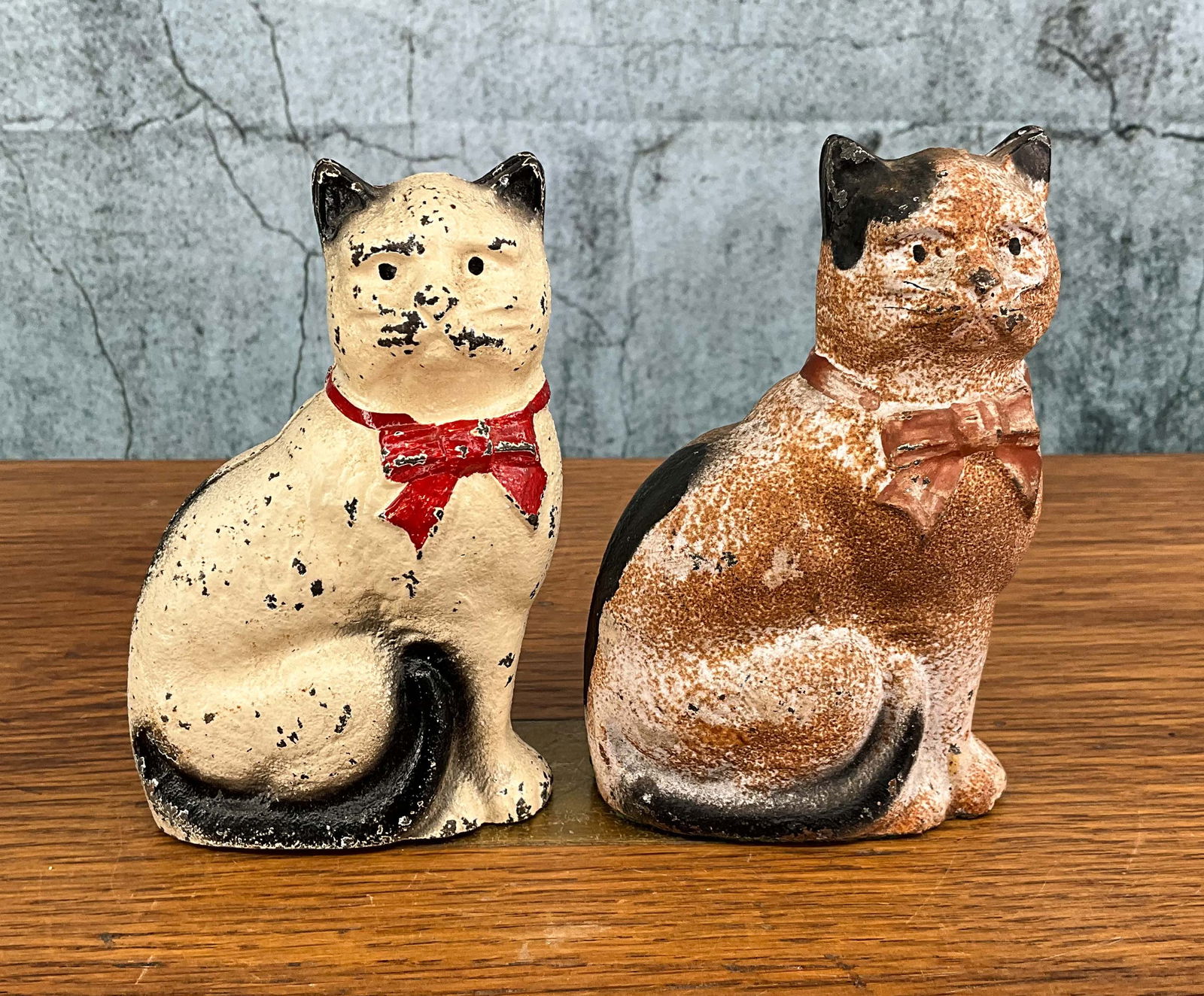 Pair Cast Iron John Wright Seated Cat Penny Banks: 2 cat still banks by John Wright, 2 piece hollow form cast iron with bolt. Provenance: Single owner collection, suburban Philadelphia estate. Size: 4.5"T Shipping Note: For your convenience, we have a