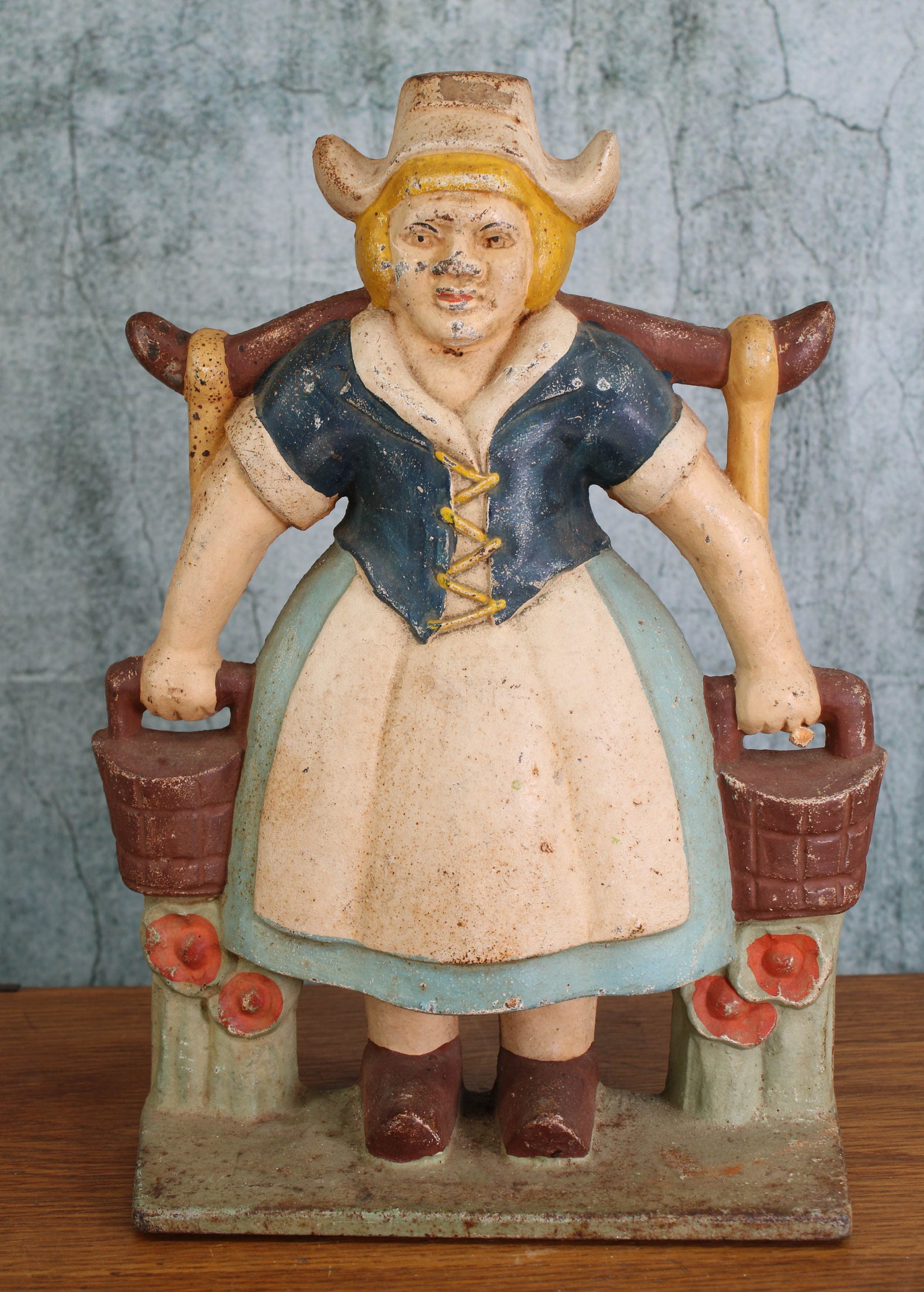 Cast Iron Dutch Girl with Pail Yoke Doorstop: Replica of Littco's Dutch girl. Cast iron, single piece, hollow form with flat back. Provenance: Single owner collection, suburban Philadelphia estate. Size: 13.5"T Shipping Note: For your convenience