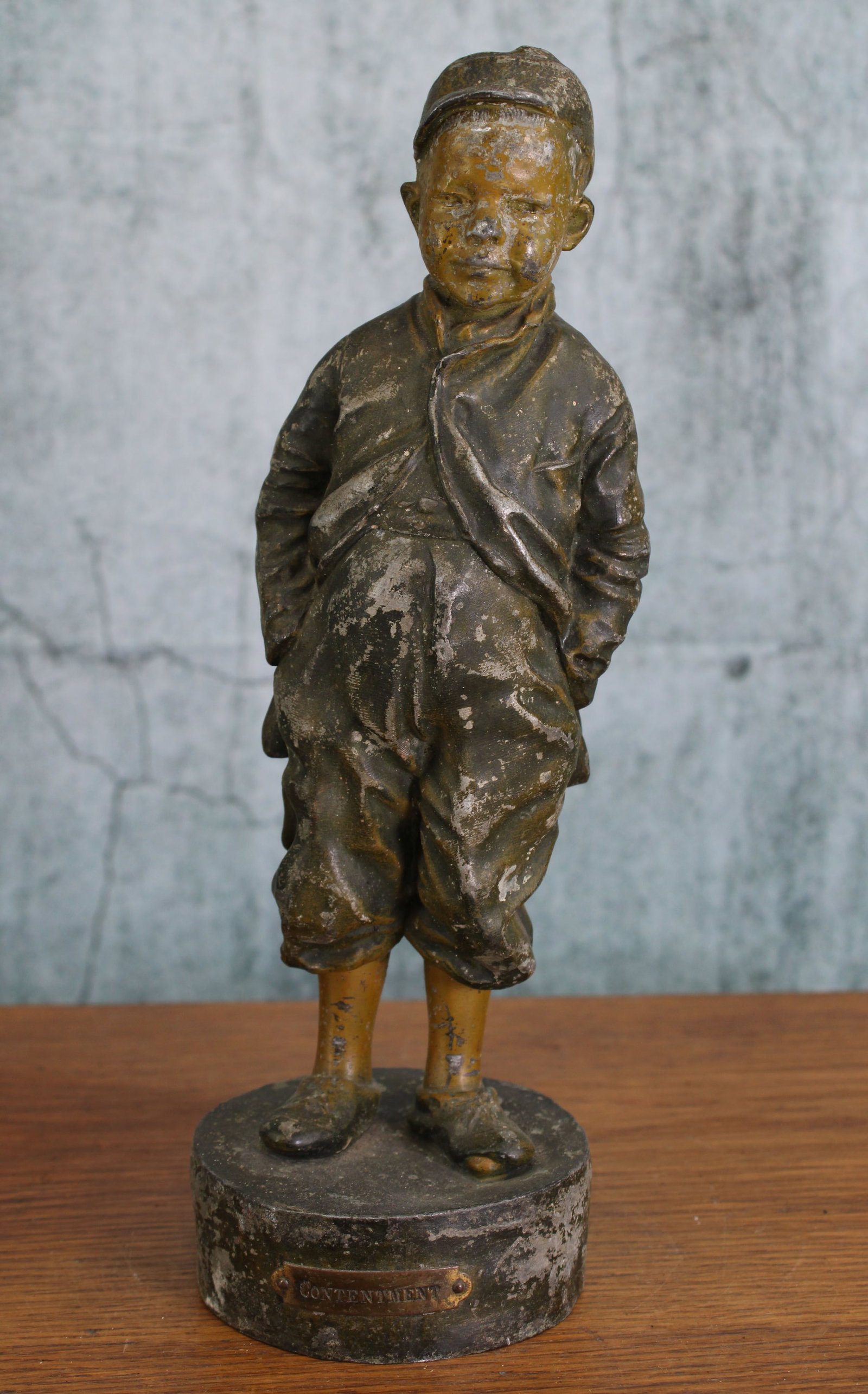 Spelter Figure. Boy, Titled Contentment: Spelter figure of young boy, title Contentment, 2 piece cast. Provenance: Single owner collection, suburban Philadelphia estate. Size: 10.75"T Shipping Note: For your convenience, we have arranged wit