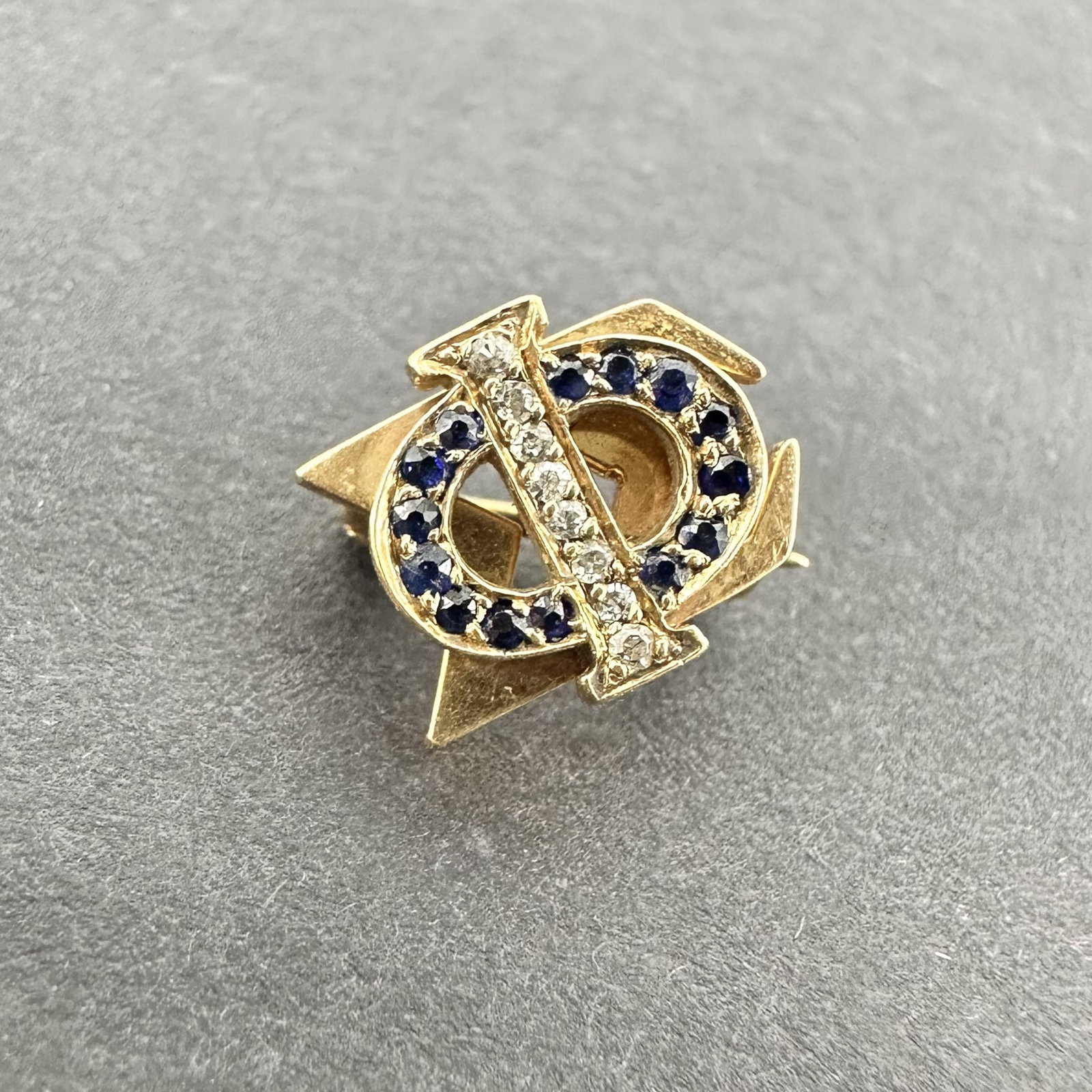 10K Gold and Diamond Sorority Pin: Phi Sigma Sigma Sorority Pin, early 20th century. Hallmarks on back are worn. Tested as 10K gold, diamonds tested as real, sapphires unable to test, inconclusive results. Size: 8mm x 9mm; 1.5g; stones