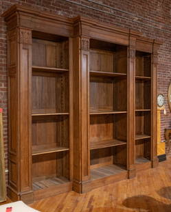 Continental Carved Oak Library Bookcase: A Monumental Continental carved oak open bookcase with stepped cornice over three sections flanked by column form pilasters. Size: 124"T x 145"L x 27"D Circa: 1890. List Price: $32000