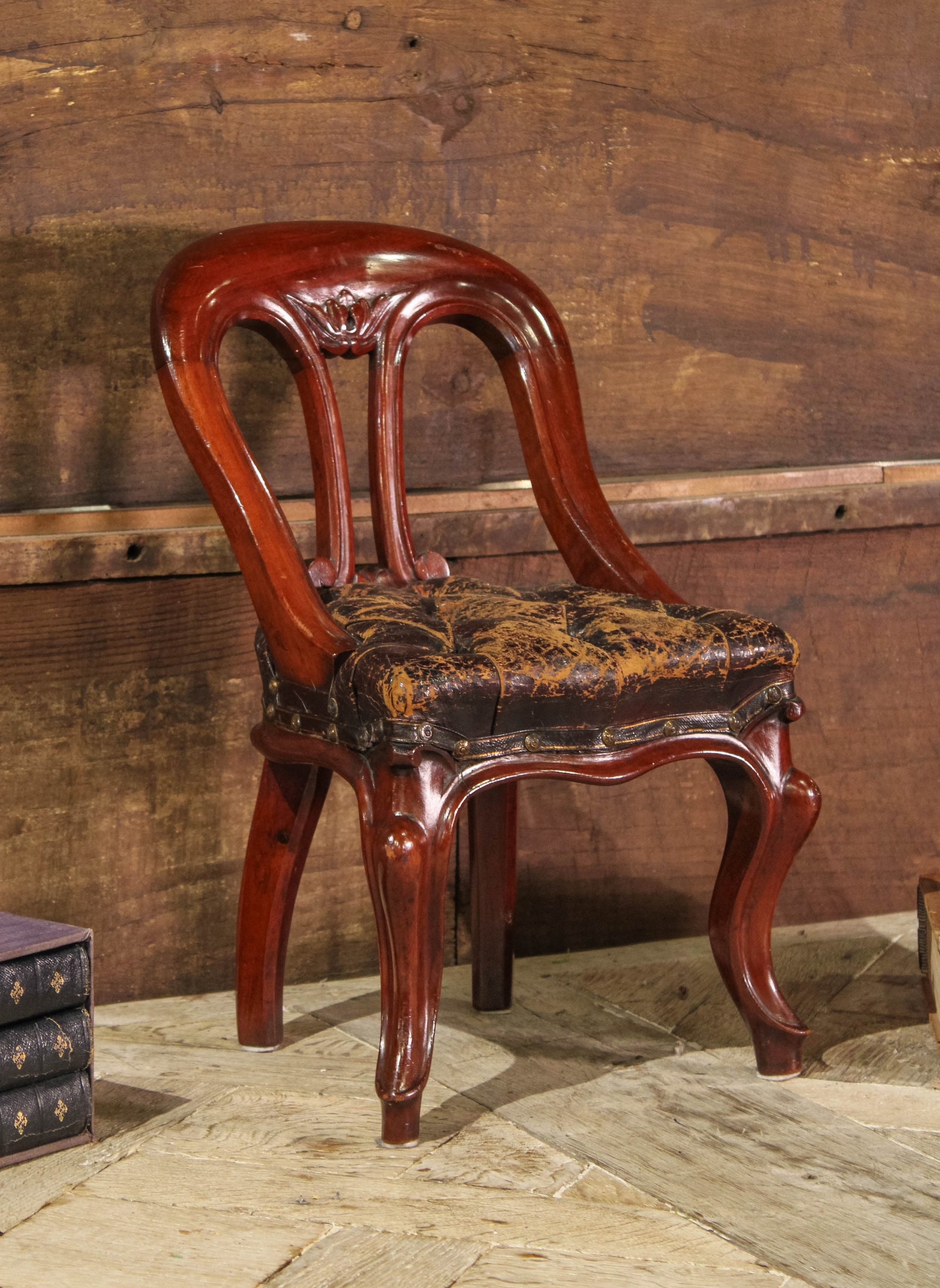 Child Sized Scottish Mahogany & Leather Chair: Child or Doll's chair in mahogany and black leather. Size: 18.25"T x 11.5"L x 12.25"D Circa: 1860 List Price: $2400 Books not included.