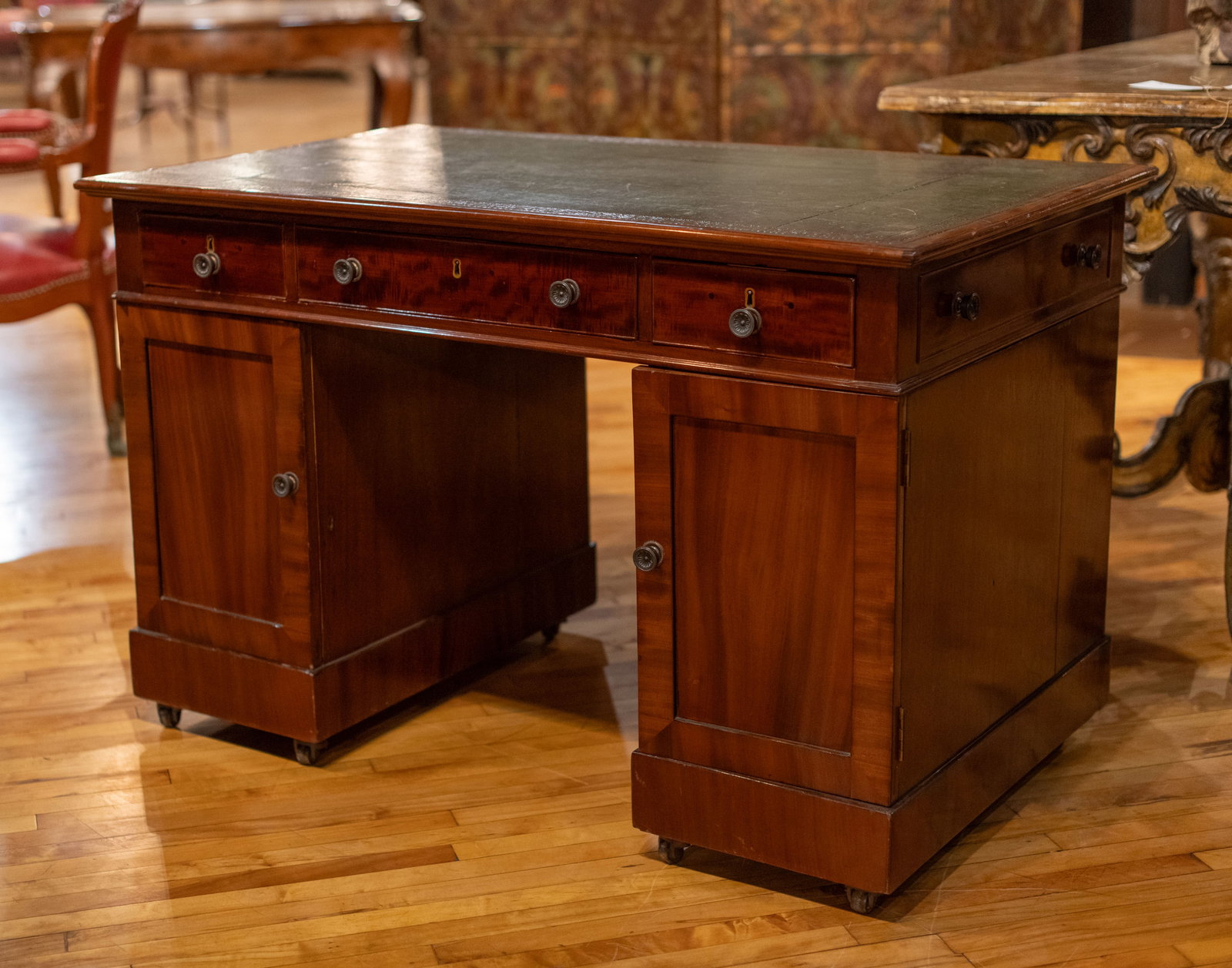 English Mahogany Leather Top Desk: 19th Century English desk having inset leather top and over three drawers and pedestal bases. Size: 32"H x 49"W x 29"D Circa: 1890 List Price: $11500