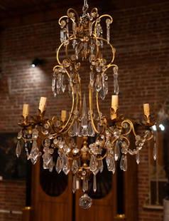 Italian Gilt And Crystal Chandelier: Italian chandelier, brass and crystal with faux candle lights. Size: 26"T x 36" diameter Circa: 1920 List Price: $6900