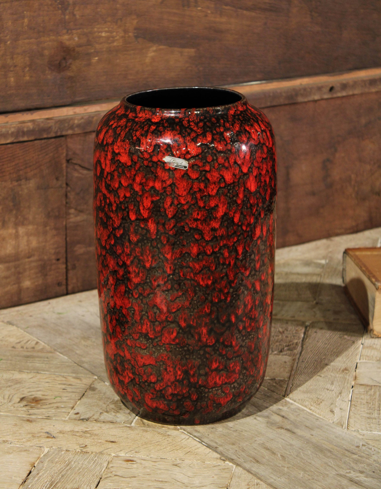 German Red & Black Lava Vase: Blown glass vase, German, Modernist. Size: 16"T x 9" diameter Circa: 1950 List Price: $790 Books not included.