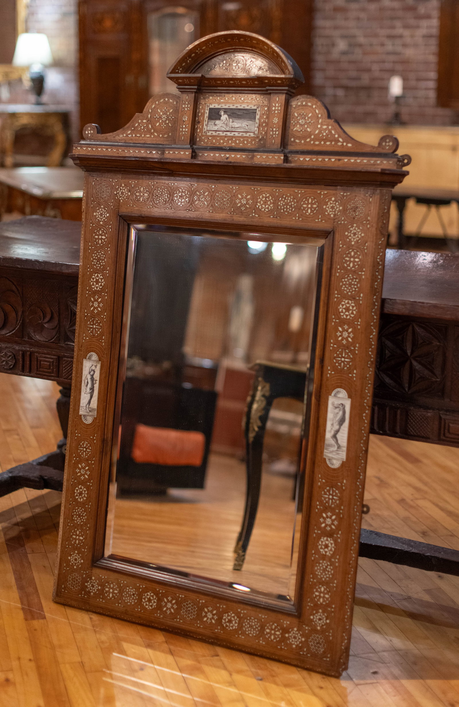 Bone Inlaid Italian Mirror: Italian inlaid beveled mirror with three bone panels having mythologically themed figures, topped with decorative crest. Size: 56"L x 35"W Circa: 1890 List Price: $8400