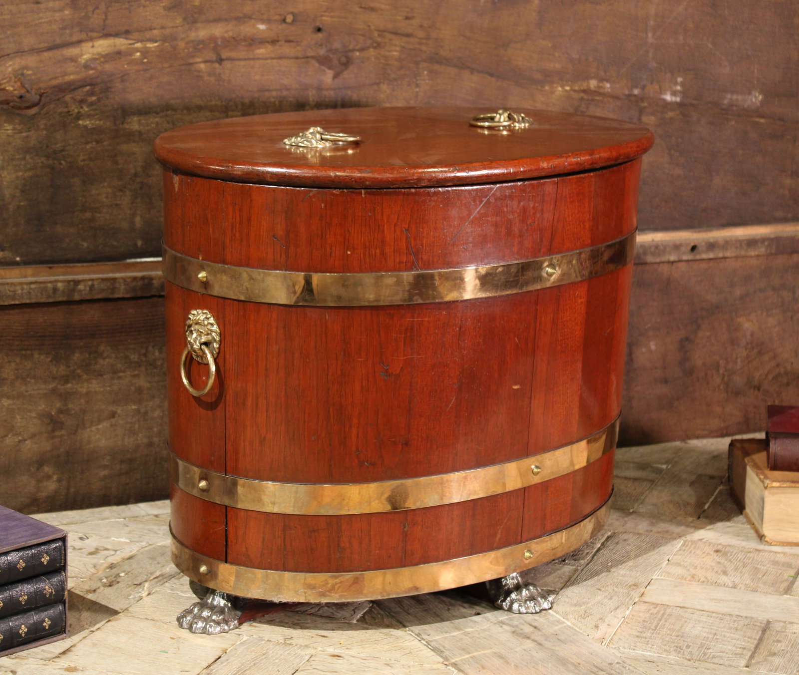 Oval Teak and Brass Wine Cooler: Wine chiller in teak wood with brass accents, claw feet and lions heads. Size: 20'T x 25.25"L x 17"D Circa: 1900. List Price: $2200