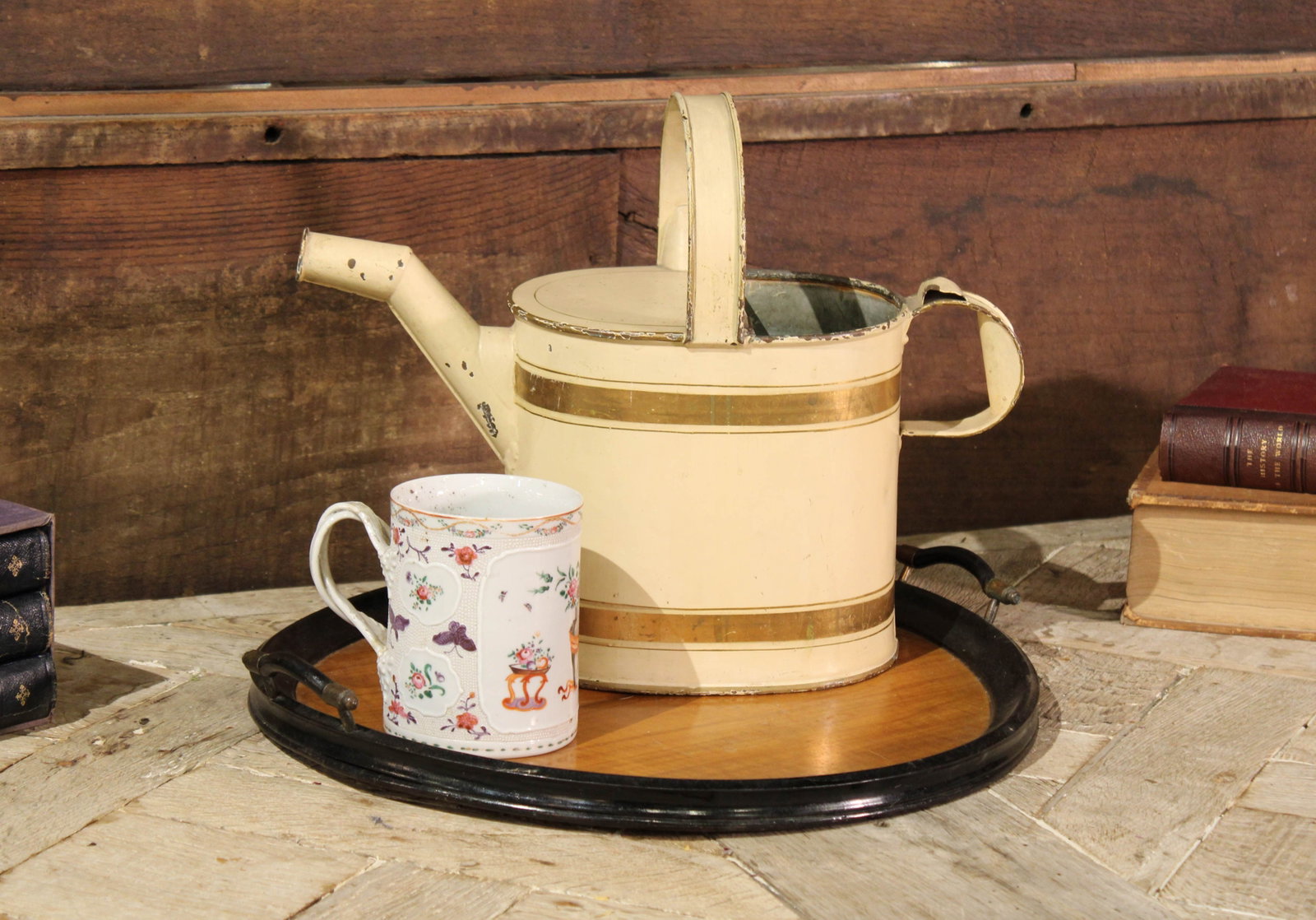 Selection Of English Decor: Collection of several English pieces, wooden tray, watering can, and porcelain mug. Size: 16.5", 12", 5.5" Circa: 1800's List Price: $2100 Books not included.