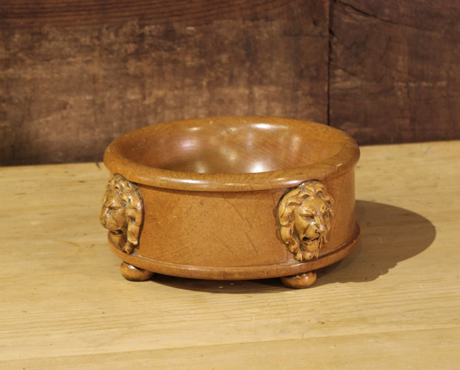 English Carved Wooden Bowl: English Carved Wooden Bowl with lion head detail and tiny bun feet. Size: 4.5" H x10" Diameter Circa: 1880 List Price: $1350
