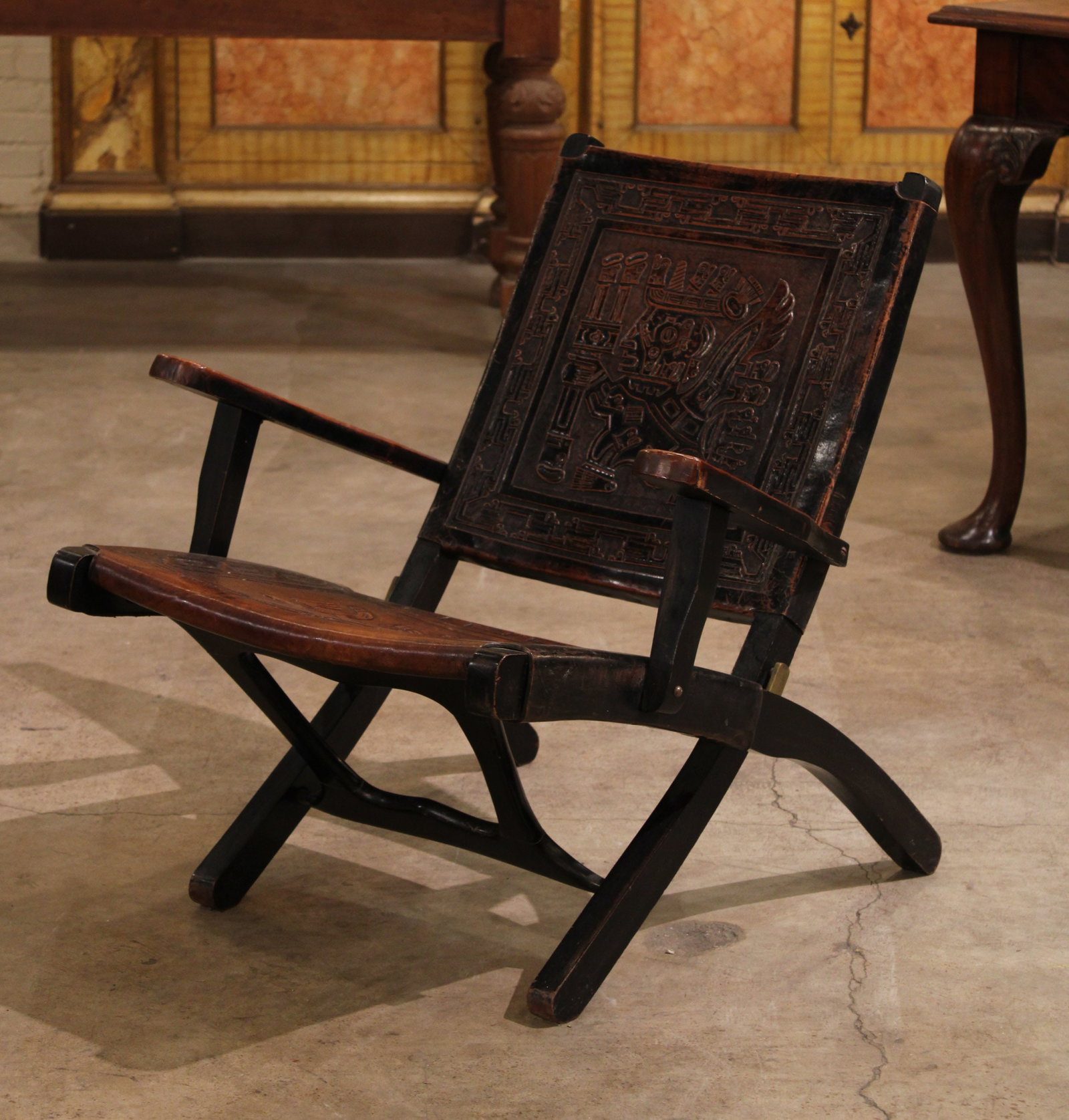 Spanish Aztec Motif Embossed Leather Armchair: Spanish Aztec Armchair, sits low to the ground, Aztec embossed imagery throughout. Size: 28"T x 27"W x 28"D, 14.5 seat height Circa: 1900 List Price: $2300