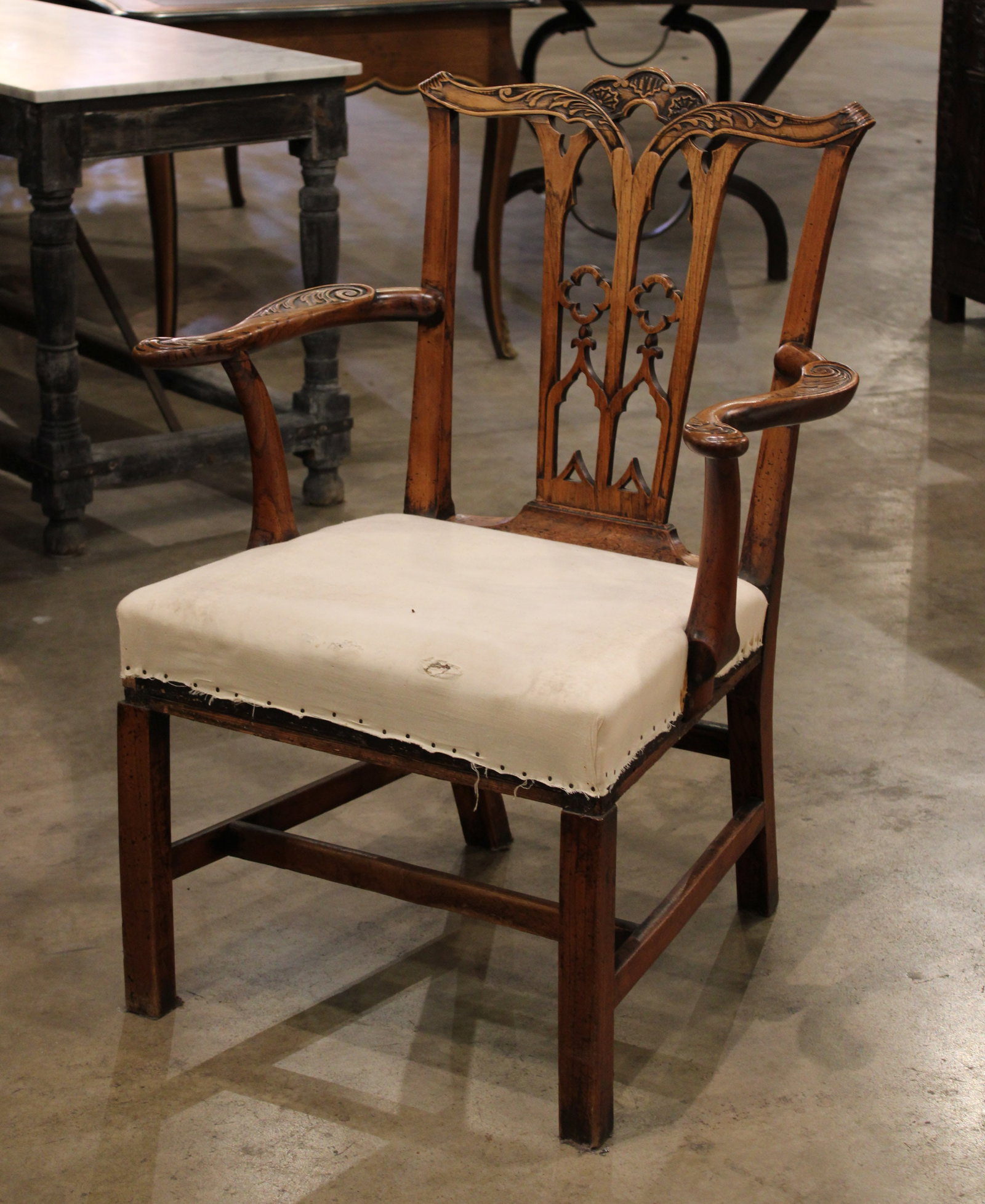 Georgian Elm Gothic Armchair: Georgian Elm Gothic Chair, carved wood with scrollwork and quatrefoil design, muslin upholstery. Size: 38"H x28"W x24"D. Circa: 1800 List Price: $7500
