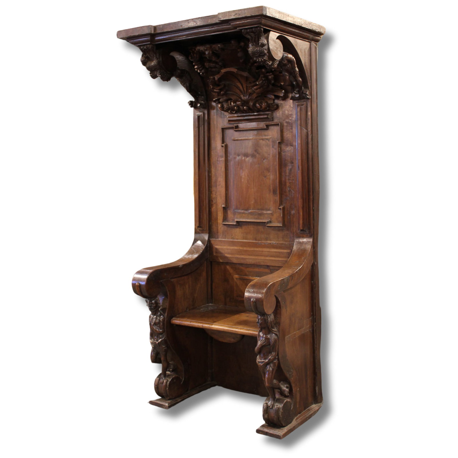19th C Italian Carved Walnut Choir Stall: 19th Century Italian carved walnut hall chair from a choir stall having overhanging cornice with figural and animal carved corbels above a paneled back and hinged seat framed by figural arms. Size:83.