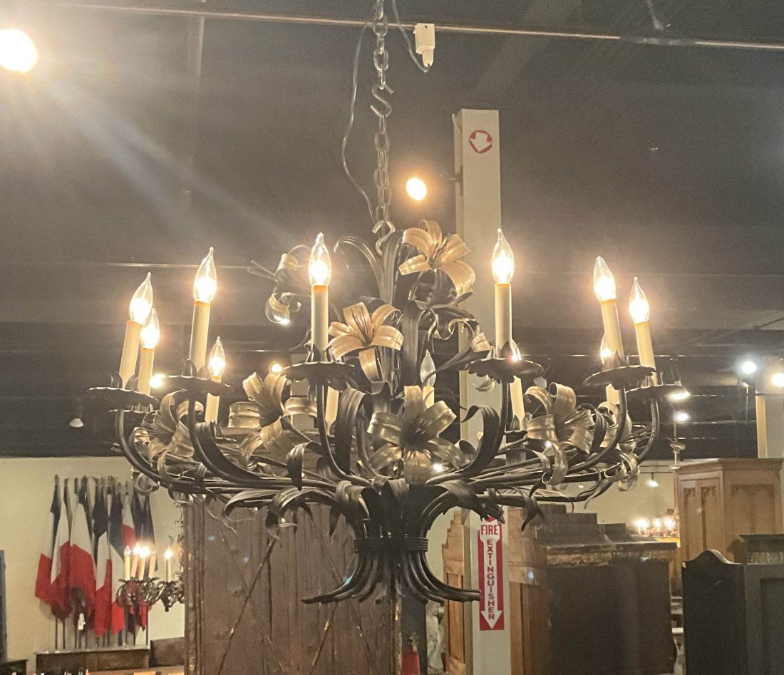Silver Tole Floral Chandelier: A mid century wrought iron and silvered tole floral decorated chandelier having twelve lights. Size: 32"H x42" diameter Circa: 1900List Price:4250